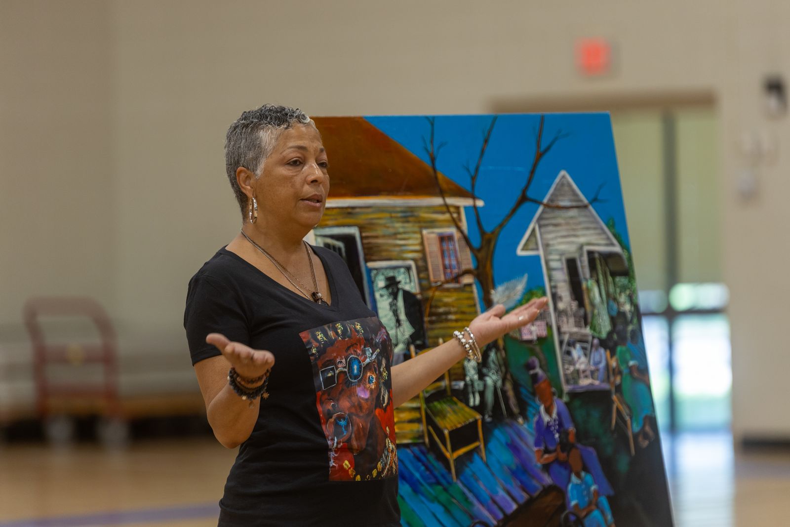Holding up one of Bryant's collages for the students